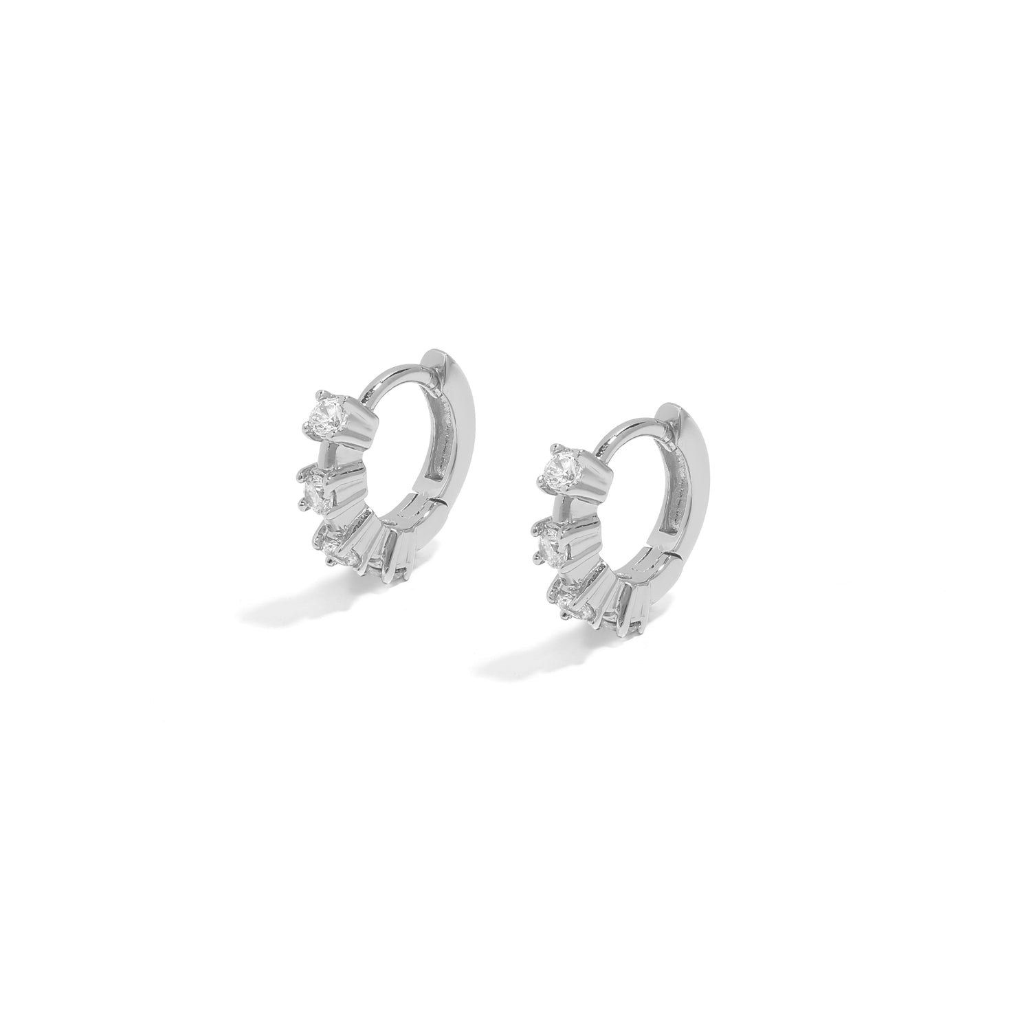 Elegant and statement huggies. Silver hoop earrings set with cubic zirconia stones.