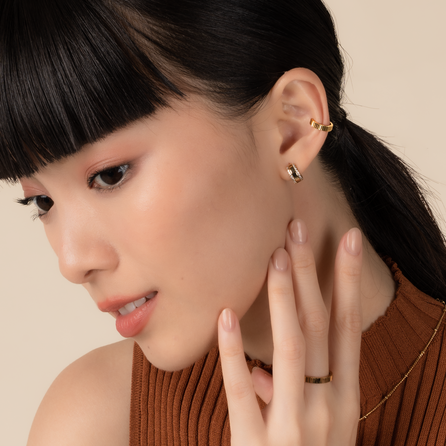 Model is wearing elegant and statement textured ear cuff in gold.