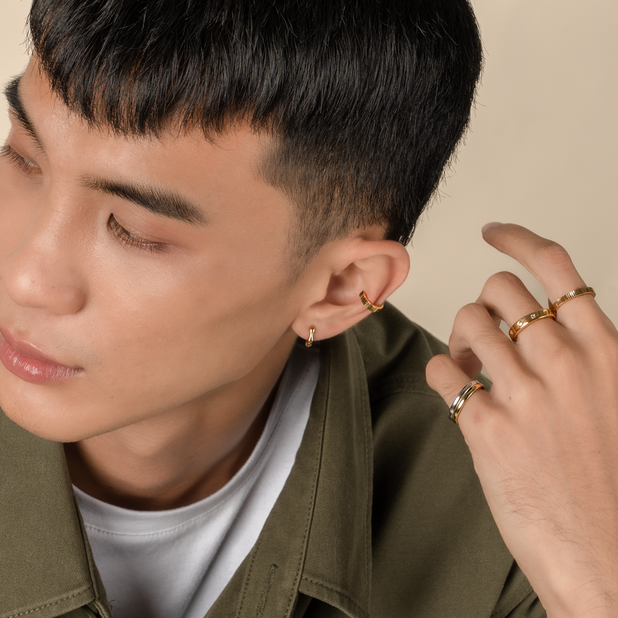 Model is wearing elegant and statement textured ear cuff in gold.