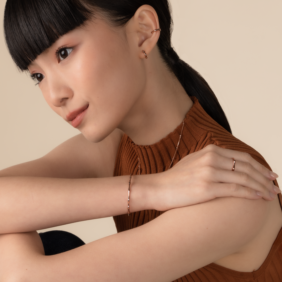 Model is wearing minimalist and sleek ring in rose gold.