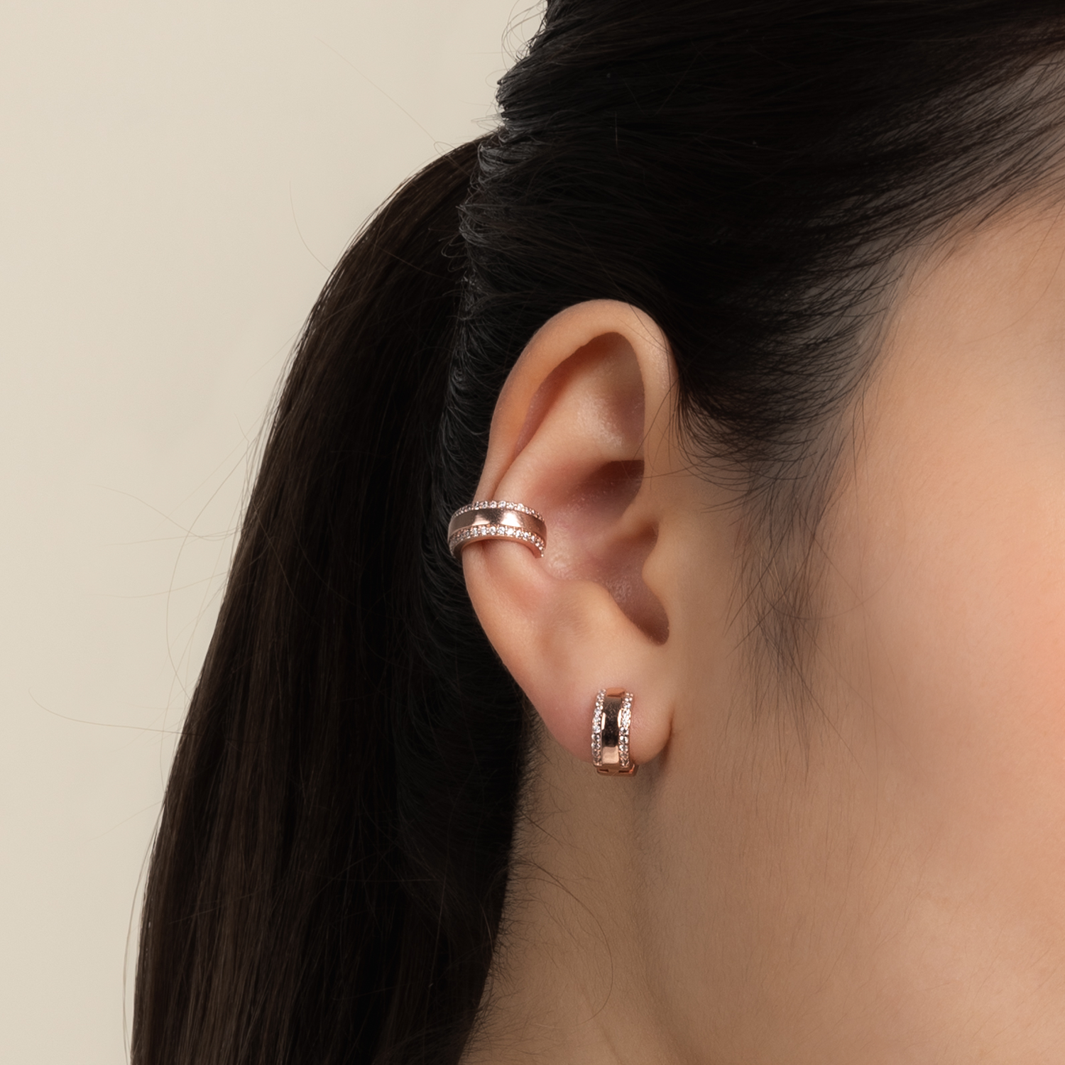 Model wears classic and elegant ear cuff in rose gold with cubic zirconia.