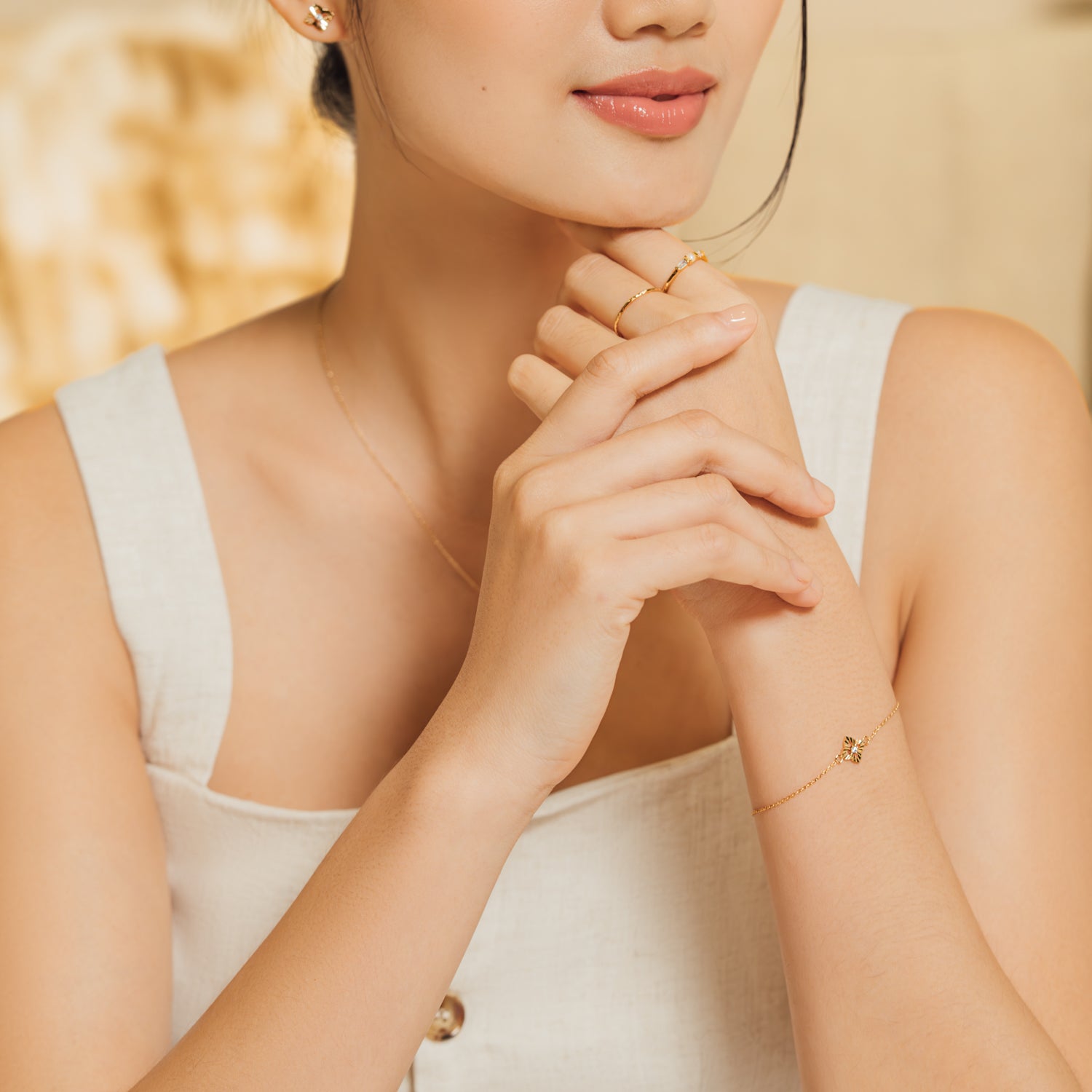 Model wearing dainty and elegant bracelet in gold with cubic zirconia.