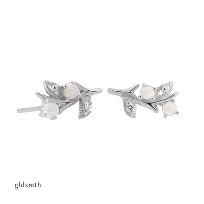 Fine and dainty studs. Solid white gold earrings set with opals and conflict free diamonds
