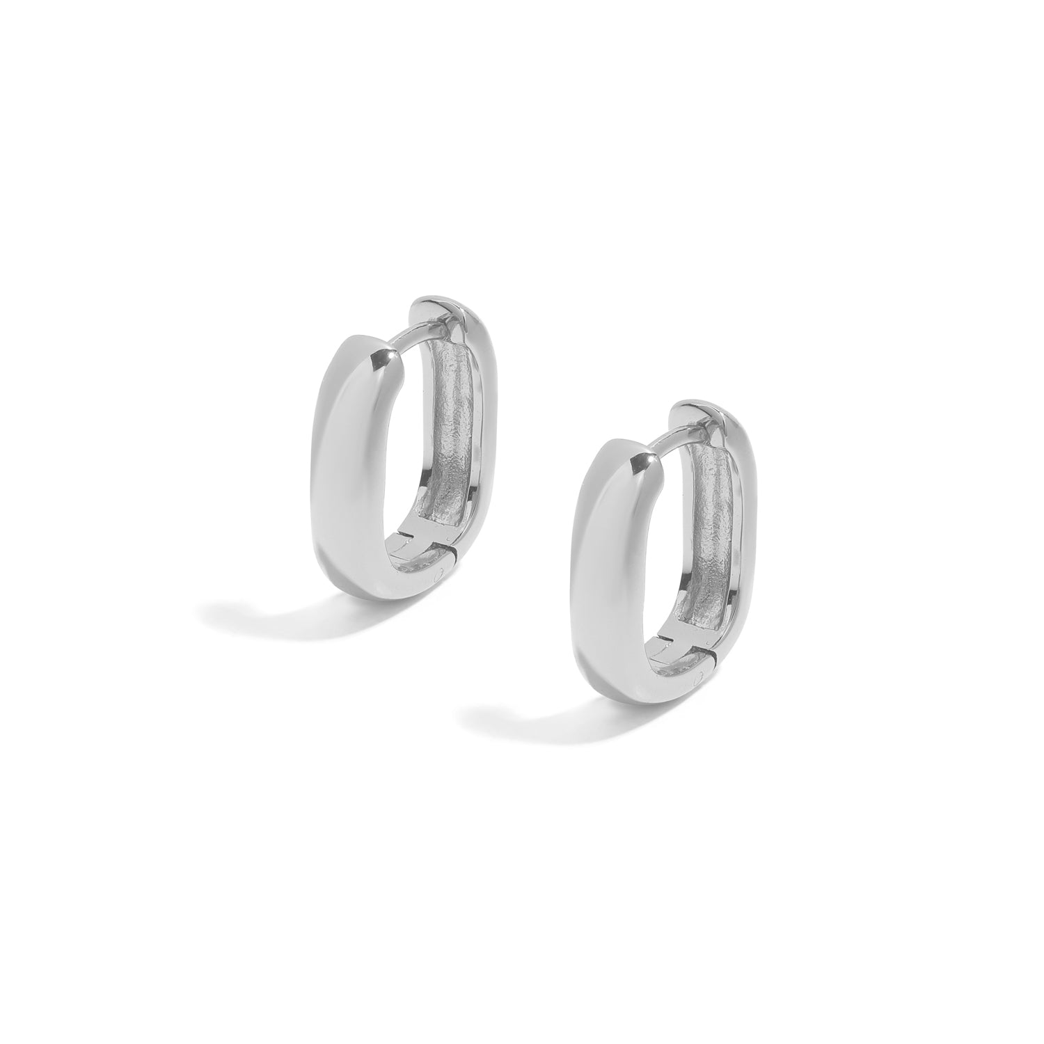 Elegant and minimalist earrings. Silver rounded huggies.