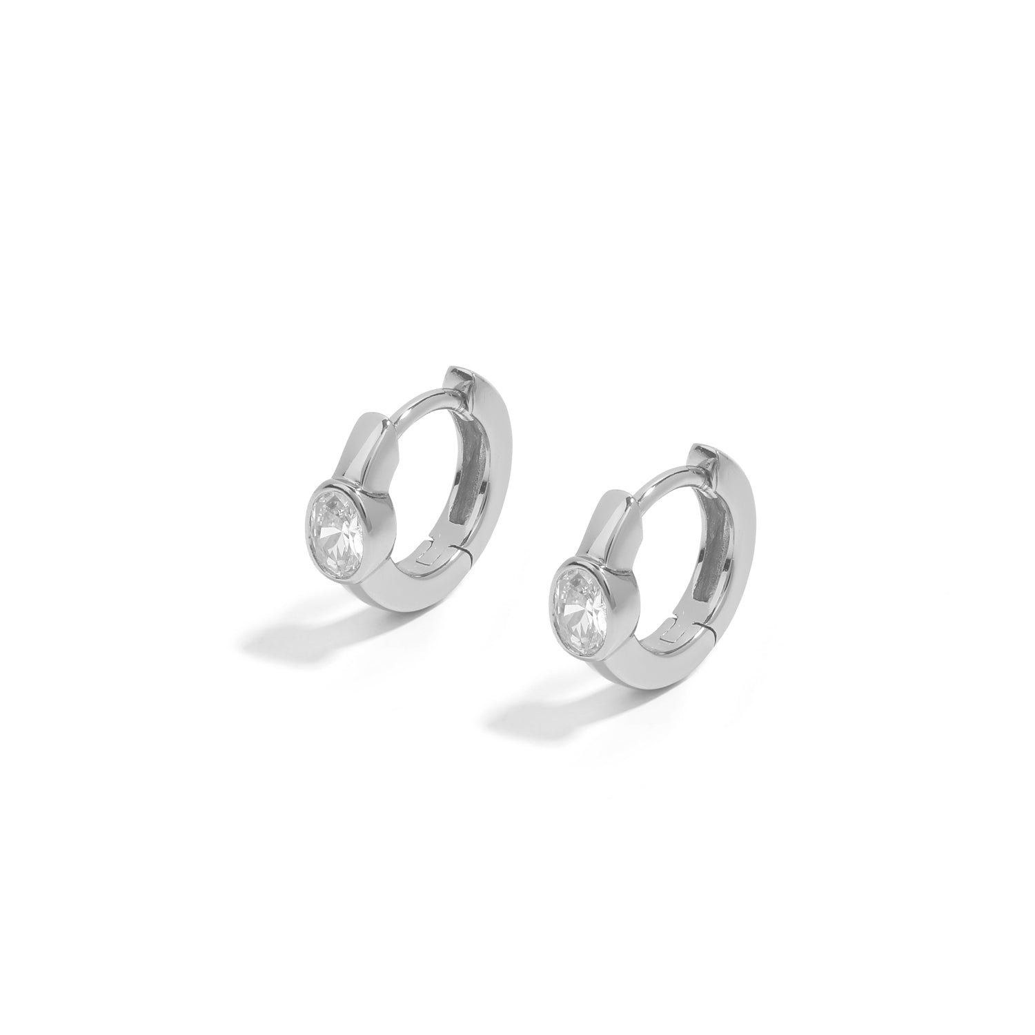 Minimalist and dainty earrings. 925 silver huggies set with cubic zirconia stones.
