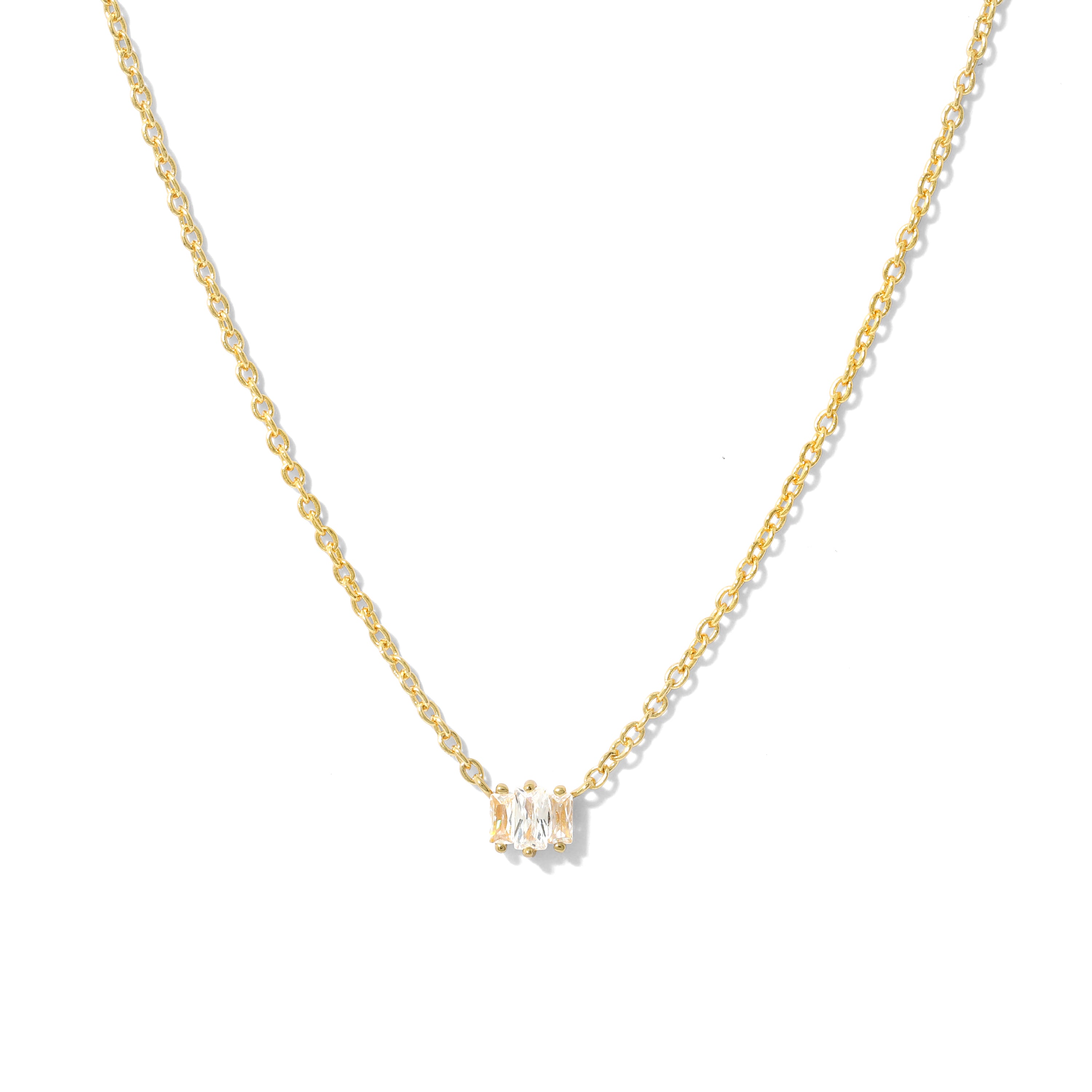 Elegant and minimalist gold necklace set with cubic zirconia stones.