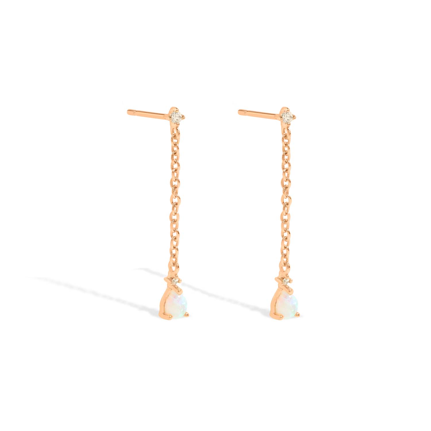 Elegant and statement drop earrings. Rose gold studs set with opals and cubic zirconia stones.