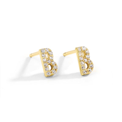 Dainty and minimalist initial studs. Gold earrings.