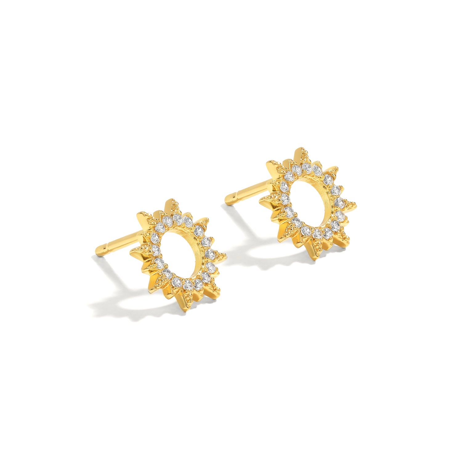 Elegant and statement studs. Gold earrings set with cubic zirconia stones.