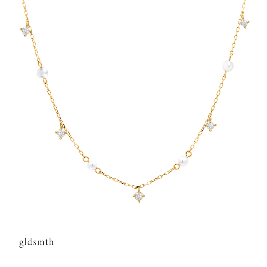Timeless and elegant hand crafted 10k solid gold necklace with freshwater pearls and conflict-free diamonds.