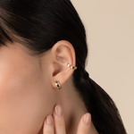 Model is wearing elegant and statement textured ear cuff in gold.