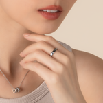Model is wearing elegant and minimalist ring in 925 silver, set with cubic zirconia stones.