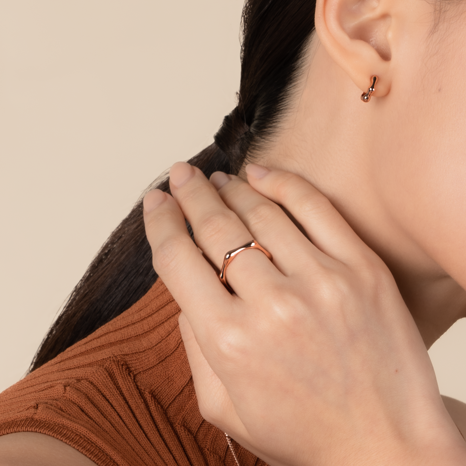Model is wearing minimalist and sleek ring in rose gold.