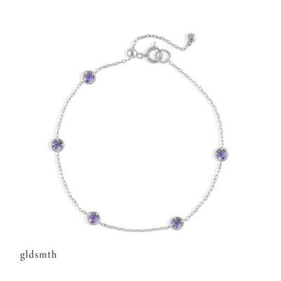 Elegant and fine handcrafted 10k solid white gold bracelet with tanzanite.