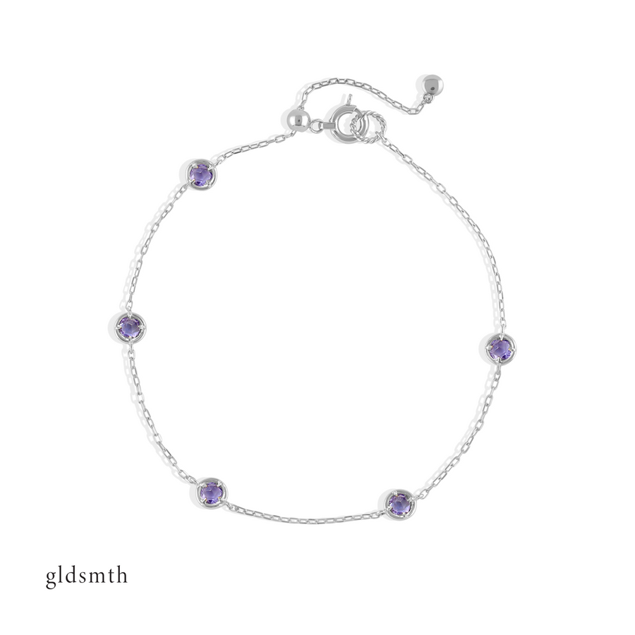 Elegant and fine handcrafted 10k solid white gold bracelet with tanzanite.