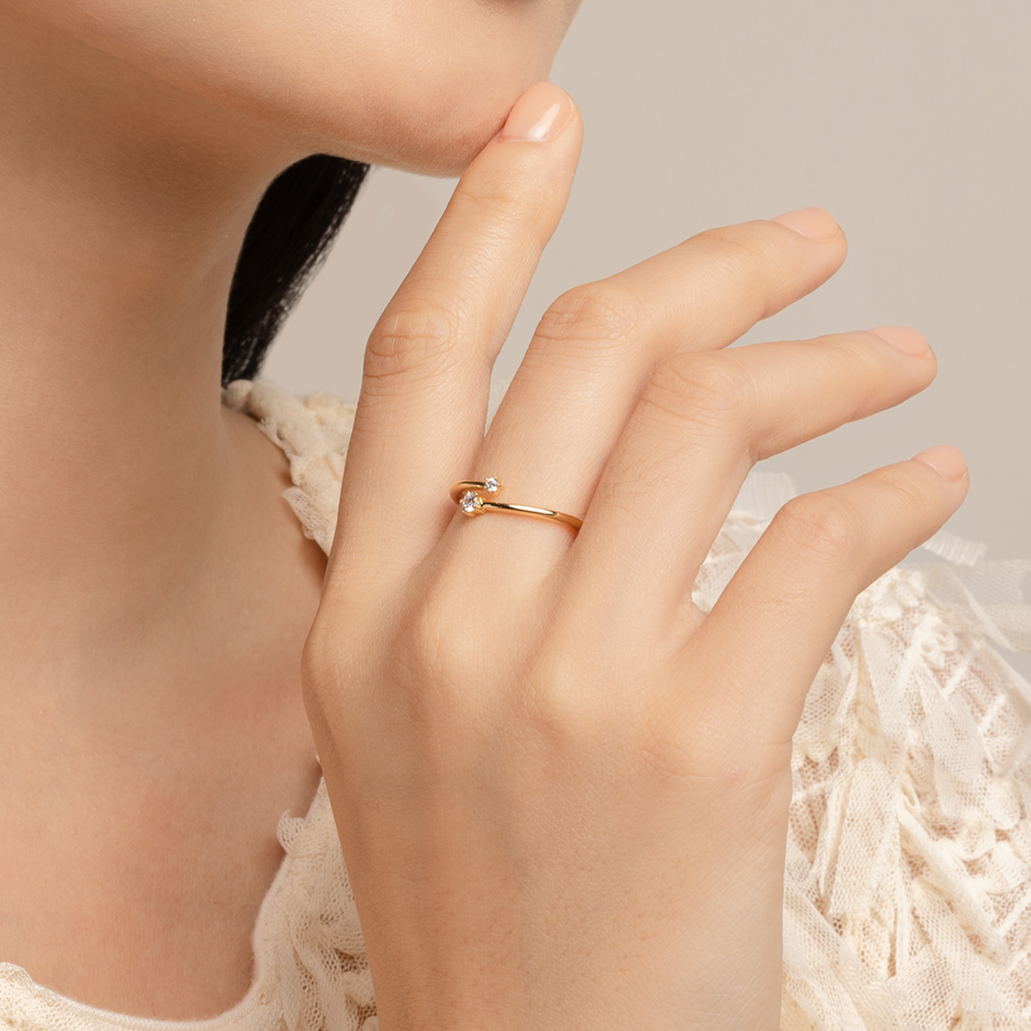 Model wears delicate and elegant ring in gold with cubic zirconia.