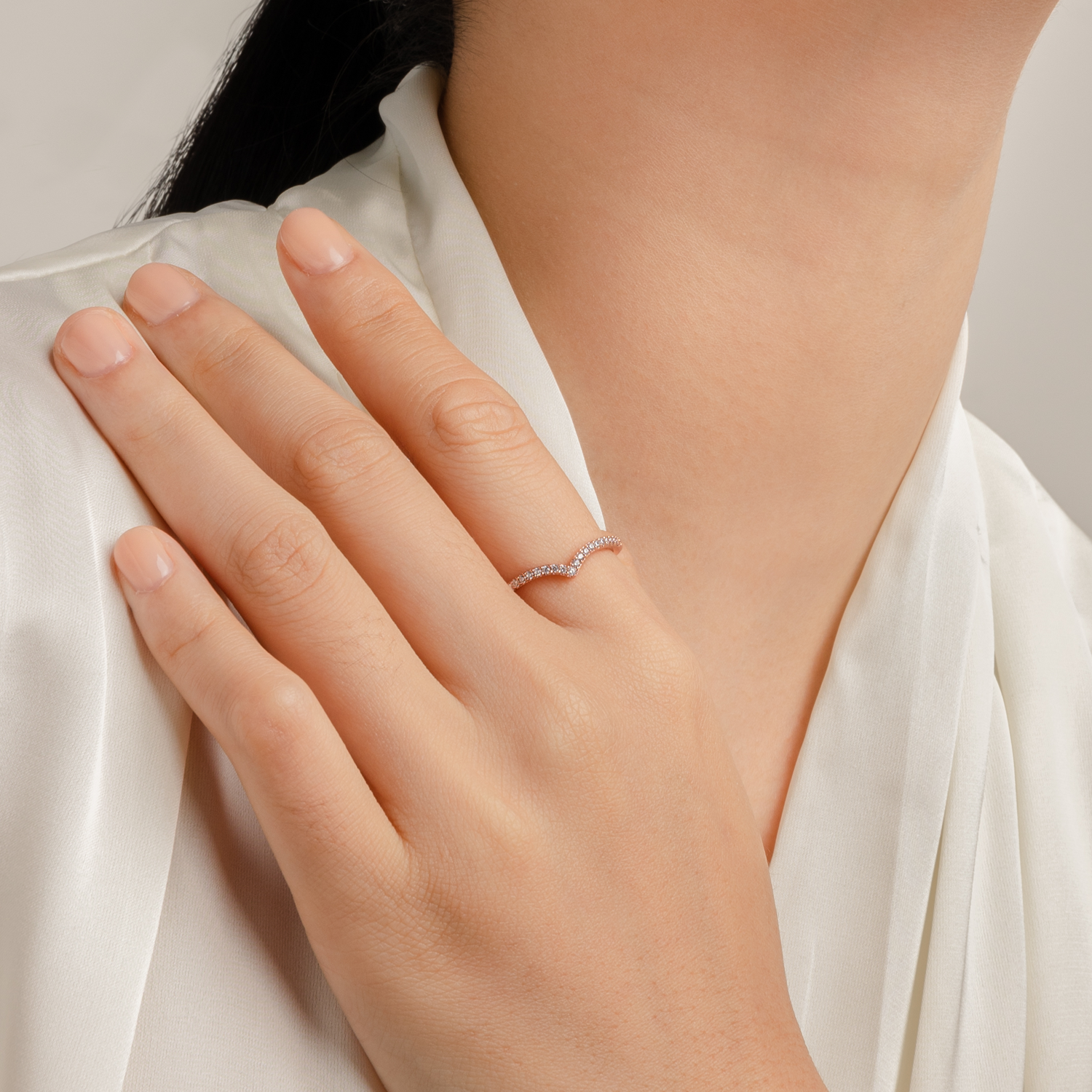 Model wears elegant and classy double ring set with cubic zirconia in rose gold.