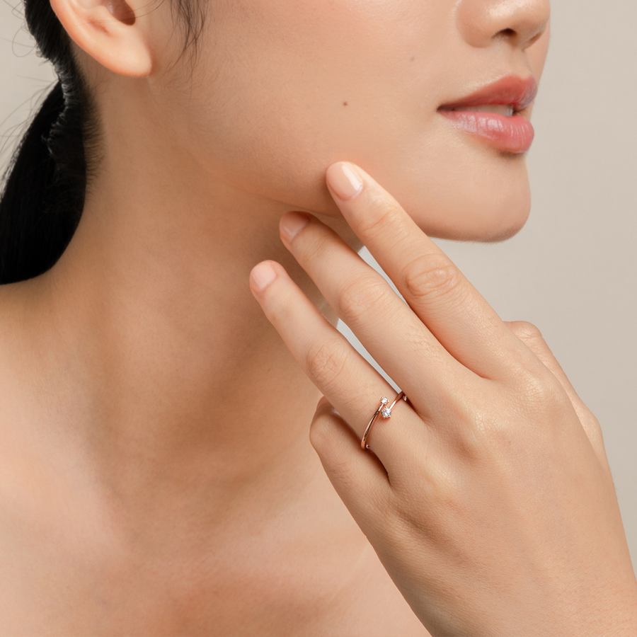 Model wears delicate and elegant ring in rose gold with cubic zirconia.