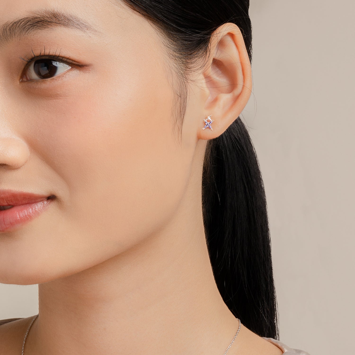 Simple and dainty earrings. Model wears 925 silver studs set with cubic zirconia stones.