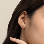 Model is wearing charming and romantic heart shaped earrings in rose gold with cubic zirconia 
