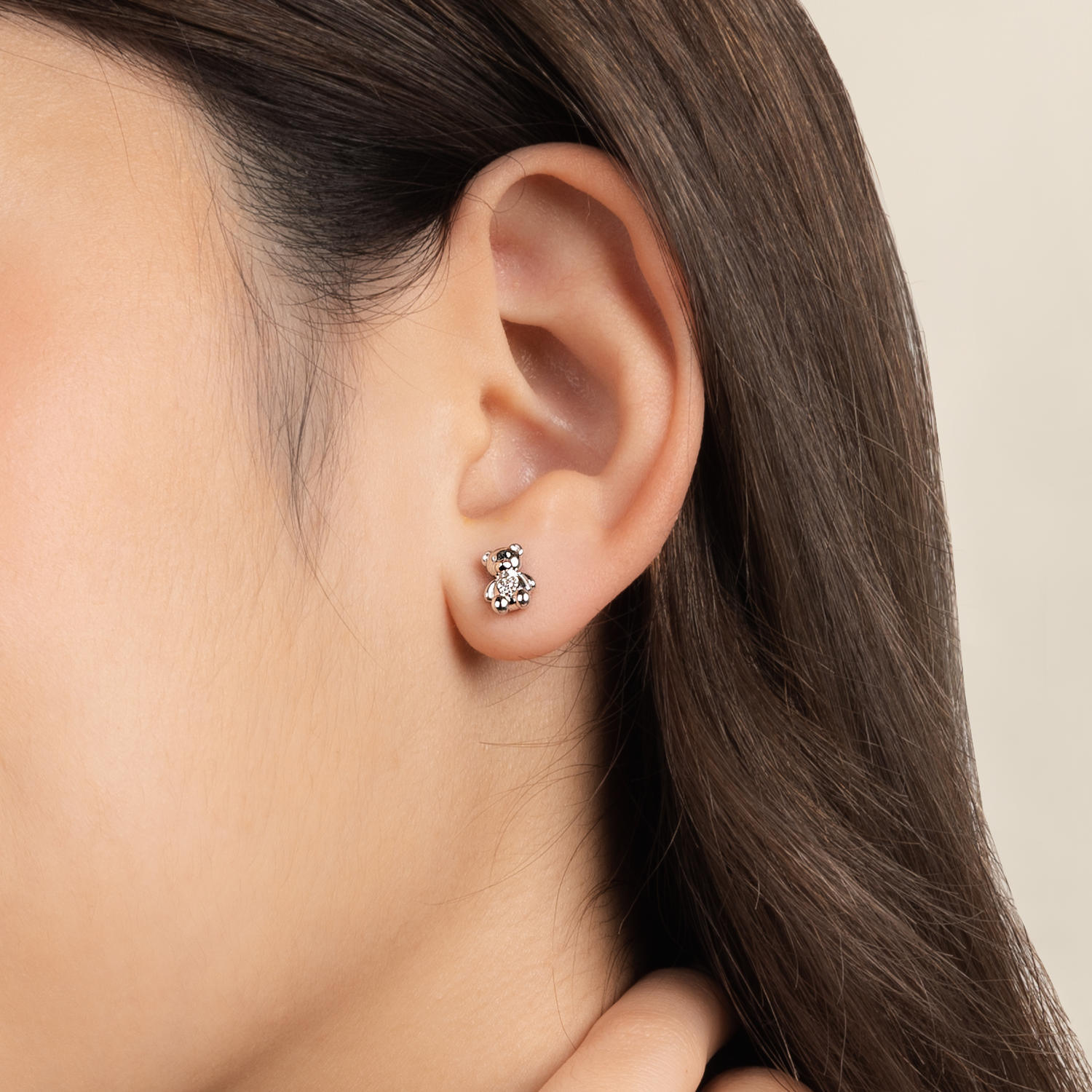 Model is wearing adorable and dainty earrings in 925 silver with cubic zirconia
