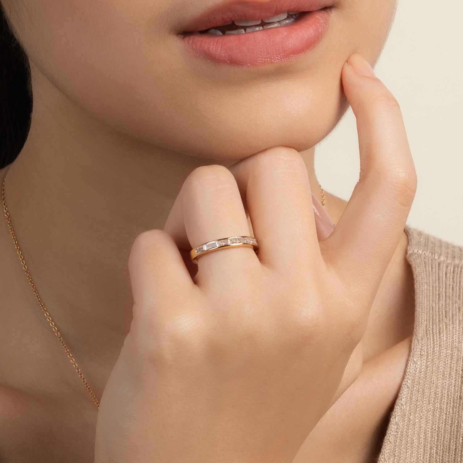 Model wears minimalist and classic ring in gold with cubic zirconia