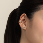 Model wears classic and elegant ear cuff in gold with cubic zirconia.