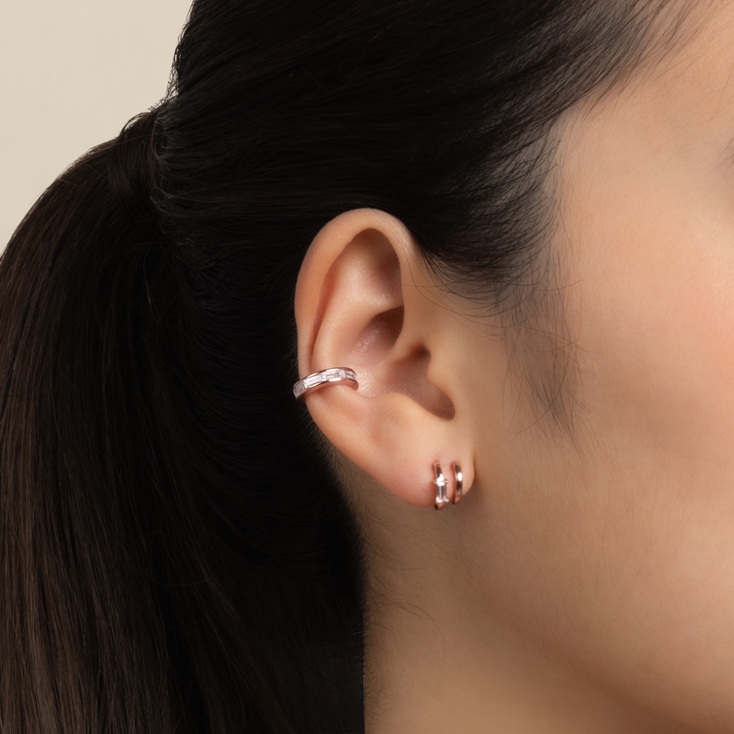 Model wears minimalist and classic ear cuff in rose gold with cubic zirconia
