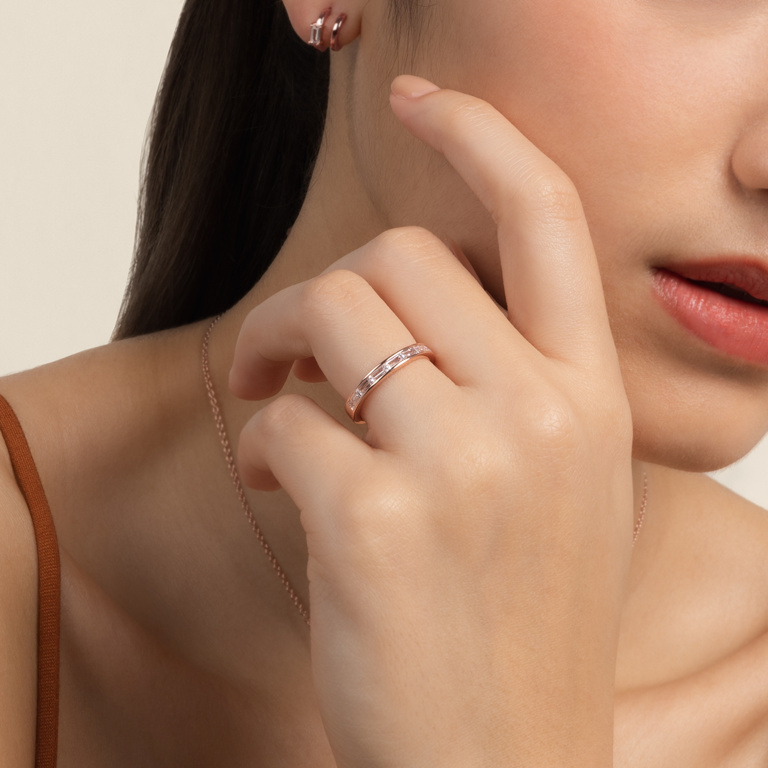 Model wears minimalist and classic ring in rose gold with cubic zirconia
