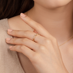 Model wears effortless and graceful ring in gold with cubic zirconia.
