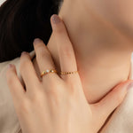 Model wears elegant and minimalist gold ring.