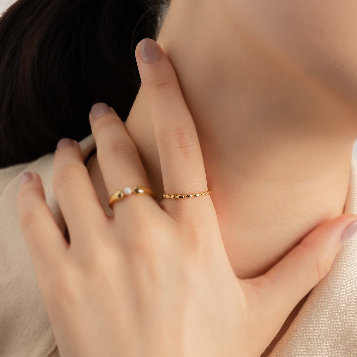 Model wears elegant and minimalist gold ring.