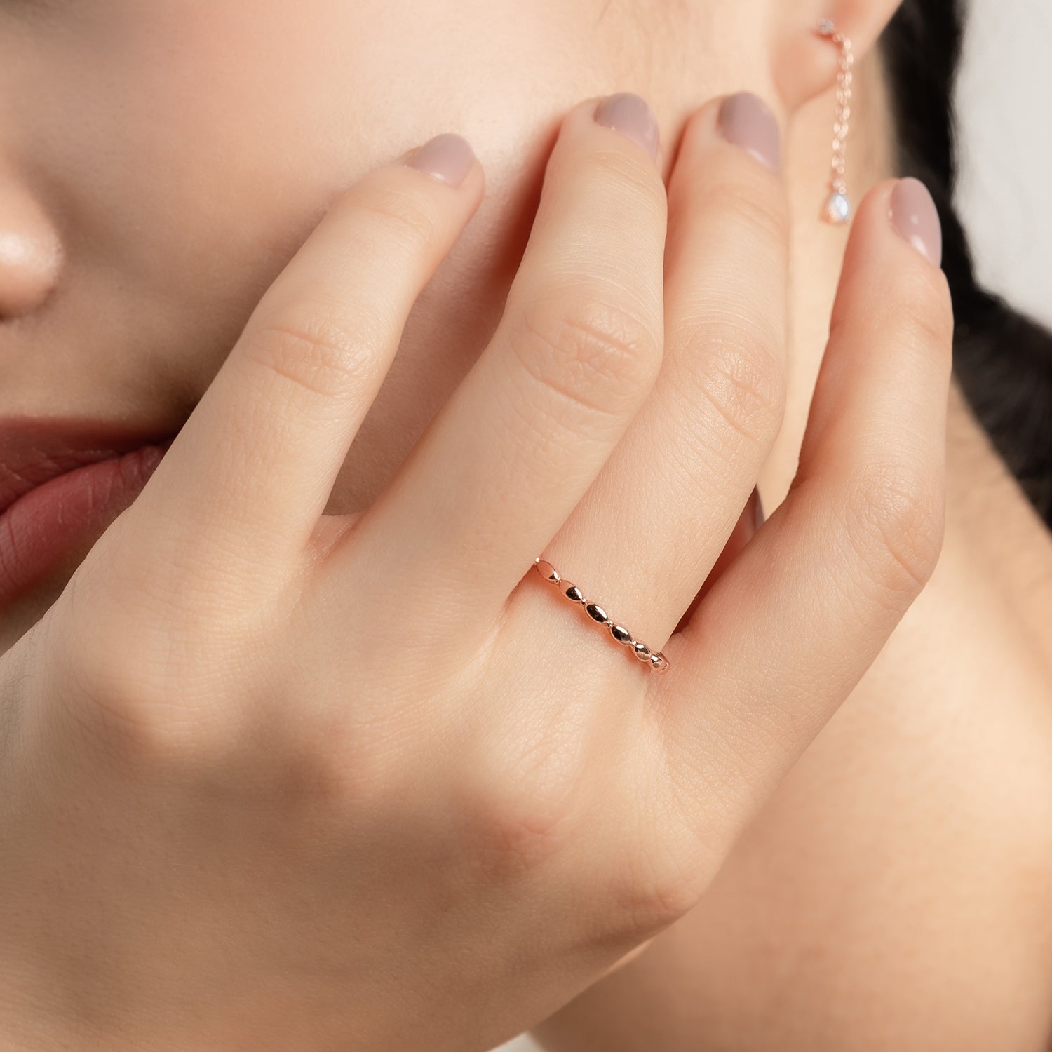 Model wears elegant and minimalist rose gold ring.
