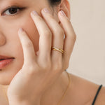 Elegant and minimalist ring. Model wears gold double ring set with cubic zircona stones