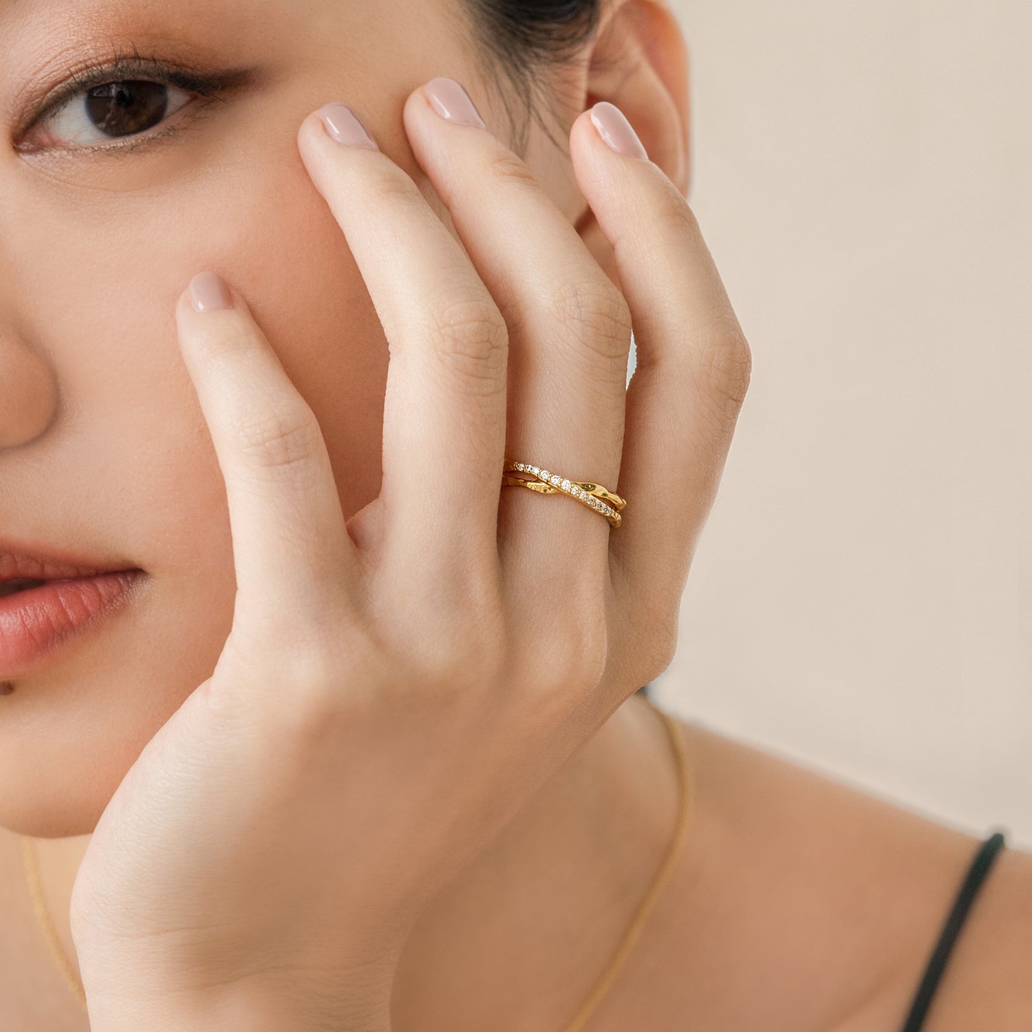 Elegant and minimalist ring. Model wears gold double ring set with cubic zircona stones