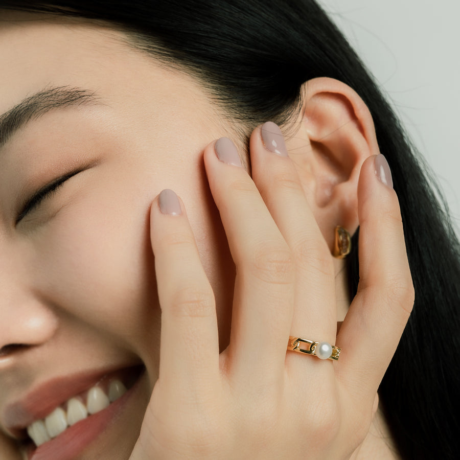 Elegant and statement earrings. Model wears gold ring set with a freshwater pearl.
