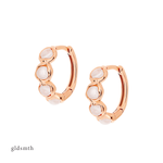 Elegant and fine earrings. Handcrafted solid rose gold huggies set with moonstones.