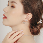 Model wears dainty and minimalist studs earrings in 925 silver with cubic zirconia